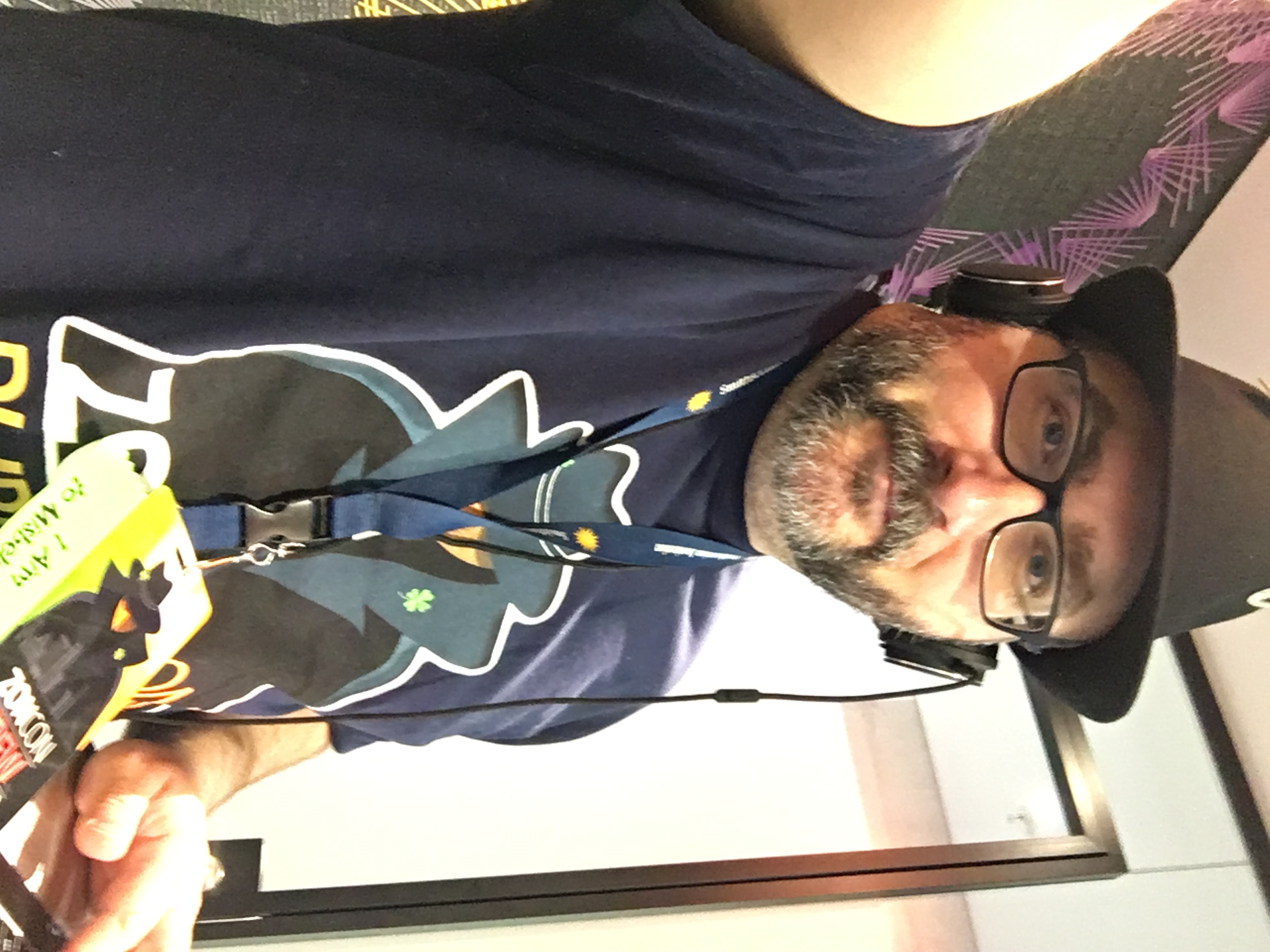 Photo of Don in a fedora and conference T-shirt, wearing headphones in front of a laptop - DJ or on a conference call?