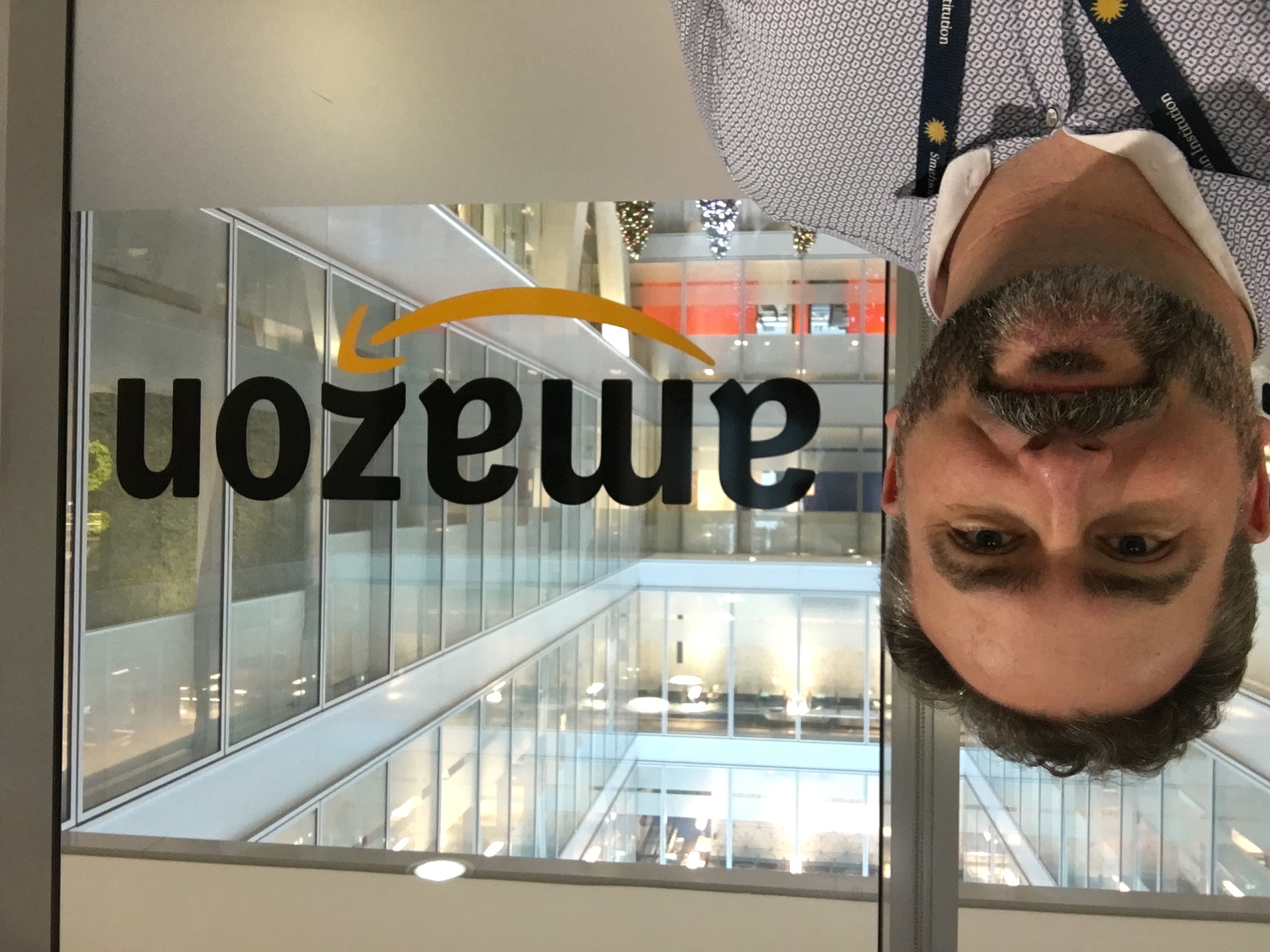 A selfie of Don in front of the Amazon logo