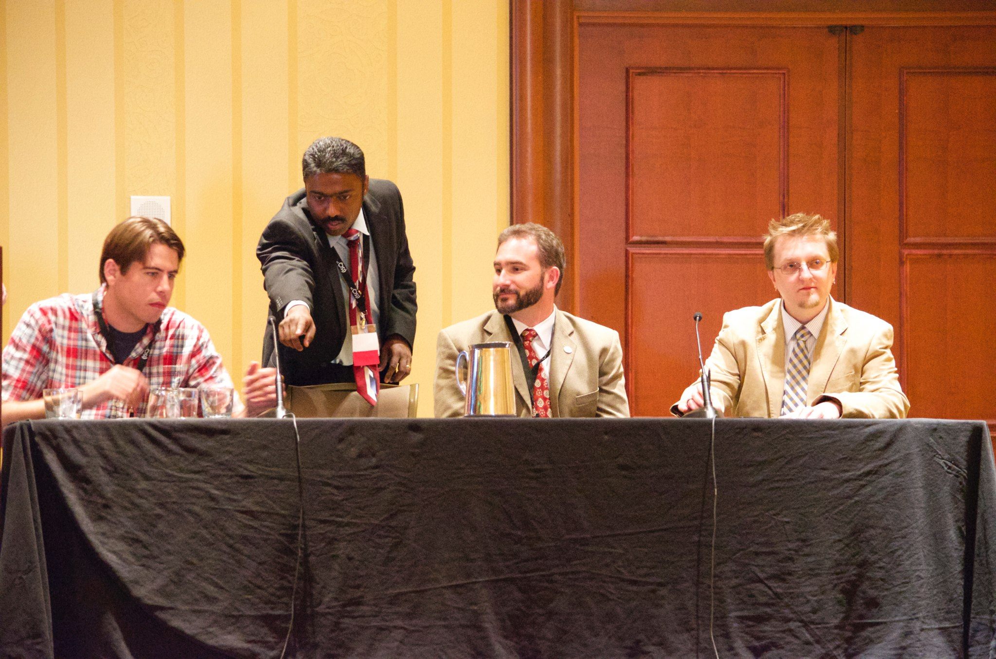 Don sitting at a table with other members of a discussion panel